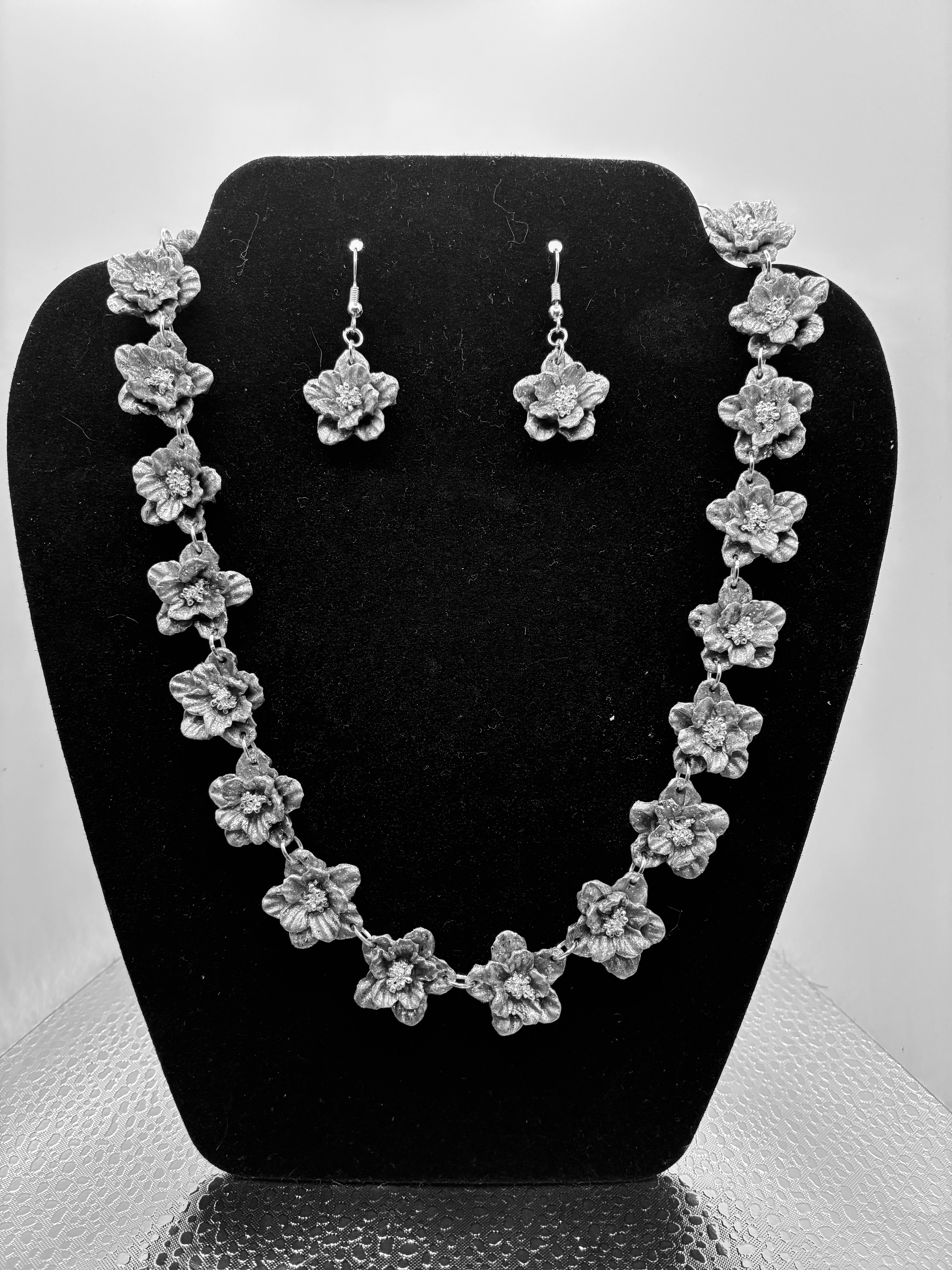 Silver-plated floral link necklace with matching flower drop earrings
