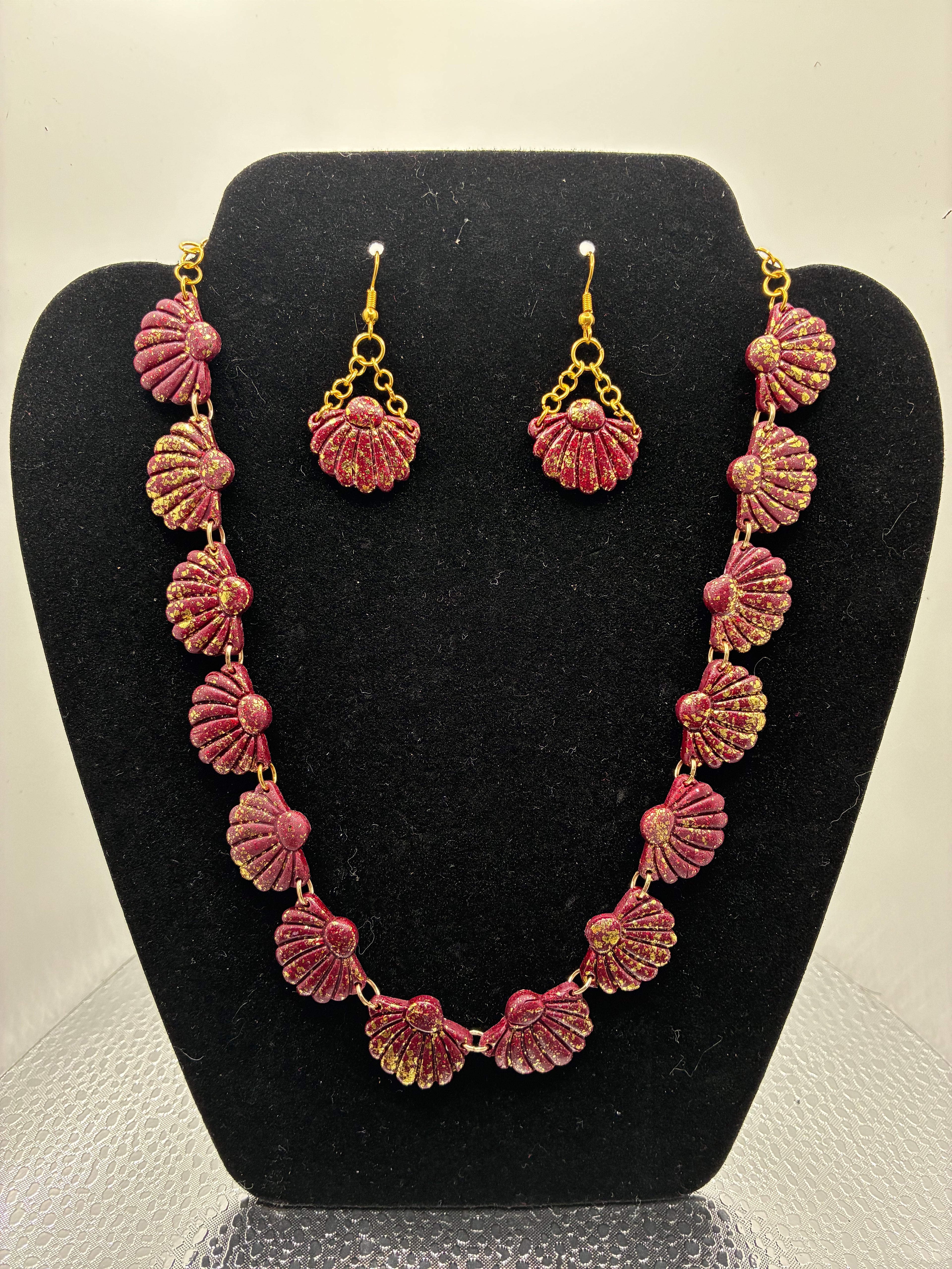 Jewelry set with necklace and earrings on a black stand