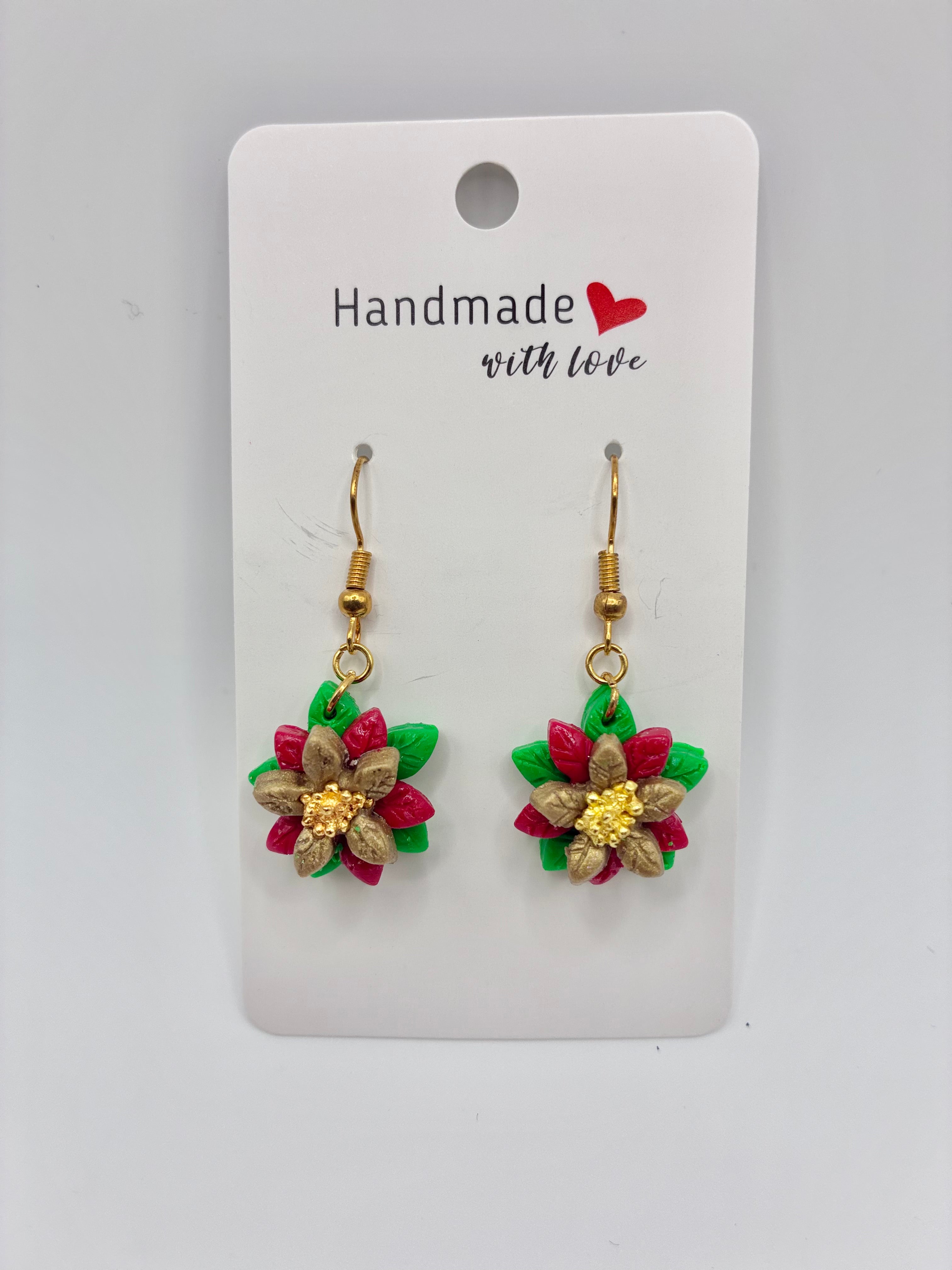 Pair of floral earrings on a 'Handmade with Love' card against a gray background
